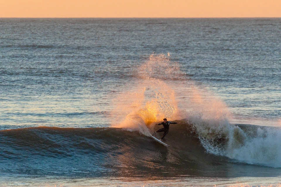 Surfer at sunset in Porto